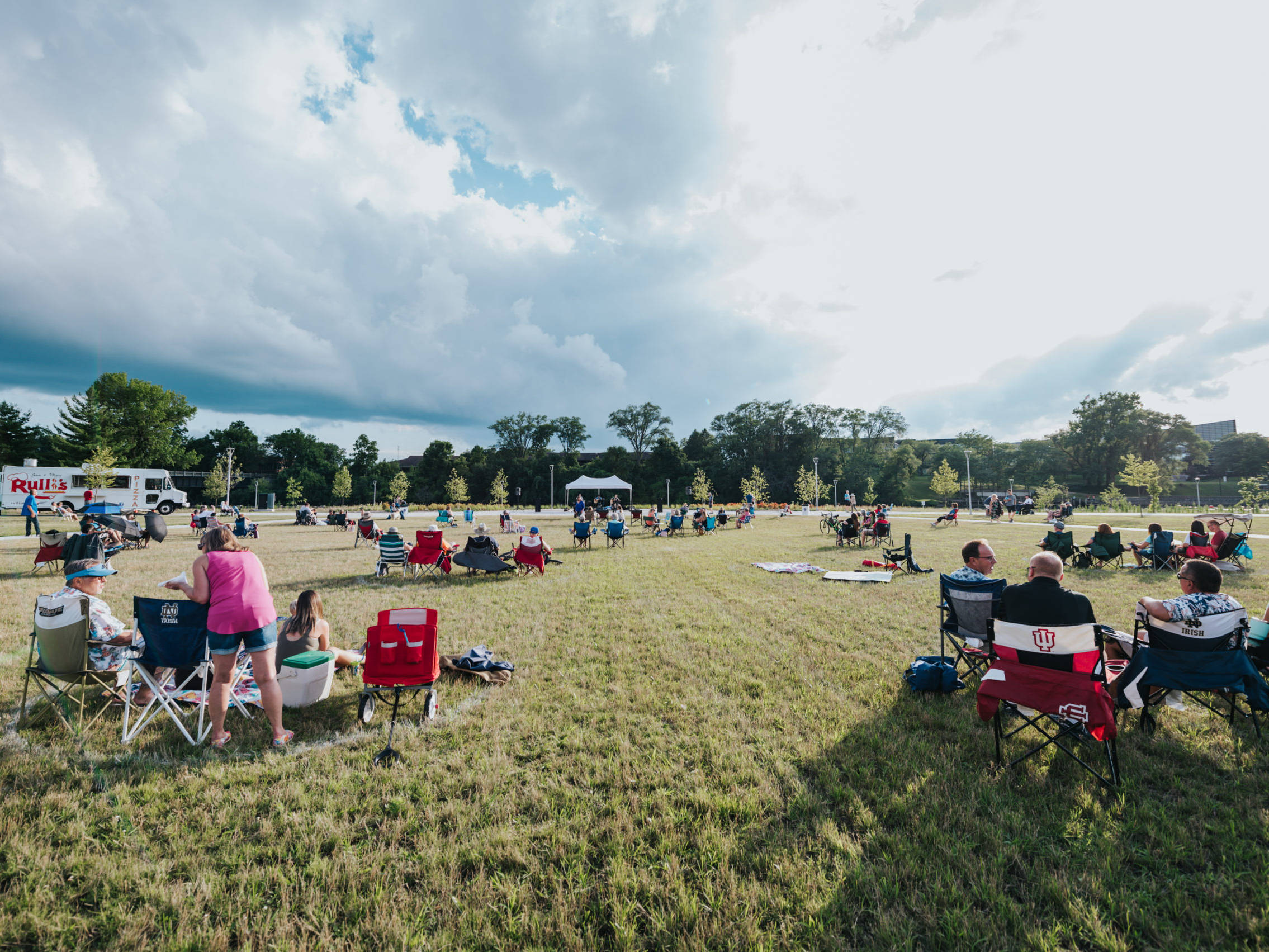 People set up lawn chairs for a performance on the lawn at Howard Park