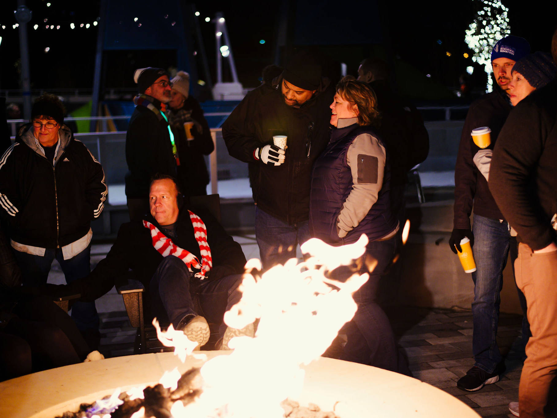 People gather around a fire pit at Howard Park